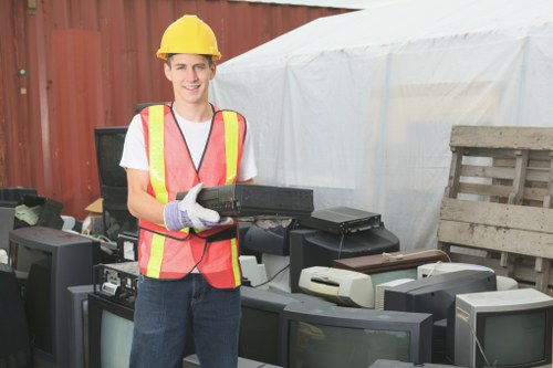 Customer service representative assisting with rubbish clearance in Colliers Wood